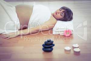 Pregnant woman relaxing on hardwood floor