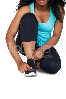 Young woman tying her shoelace