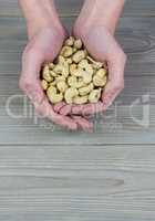 Woman showing handful of cashews