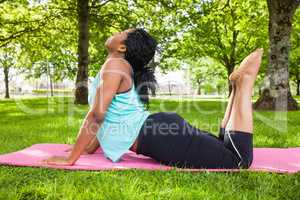 Young woman doing yoga on mat