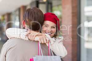 A smiling happy woman hugging her boyfriend