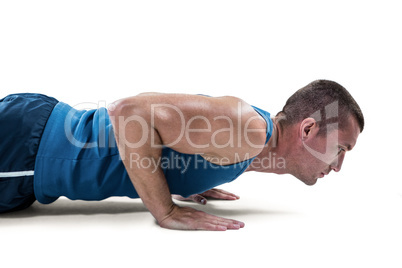 Man in sportswear doing push ups