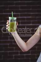 Pretty woman sipping on green juice