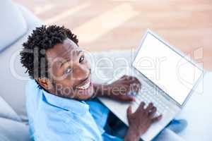 High angle portrait of man working on laptop