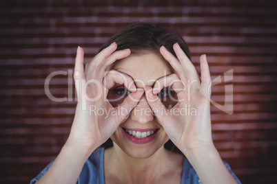 Woman holding hands as binoculars