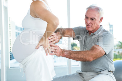 Therapist massaging back of pregnant woman