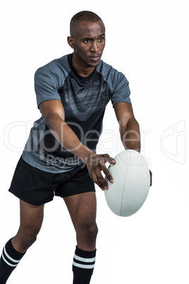 Confident rugby player in position of throwing ball