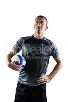 Rugby player holding ball with hand on hip