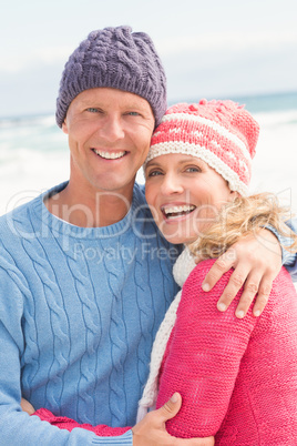 Smiling happy couple hugging each other