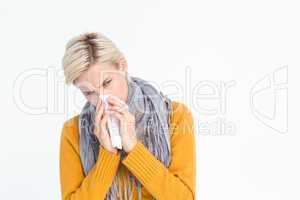 Close up of woman blowing her nose