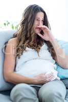 Pregnant woman crying at home