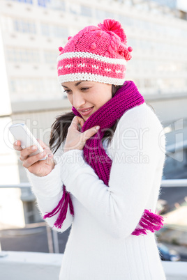 Smiling woman using her smartphone