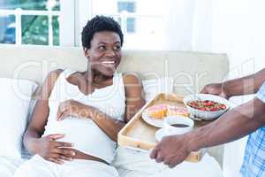 Pregnant woman smiling while looking at man