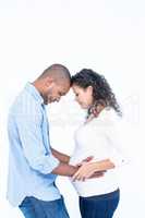 Man looking at pregnant belly against white background