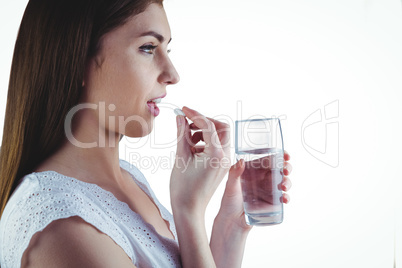 Pretty woman taking white pill
