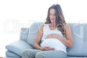 Pregnant woman sitting on sofa