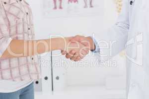 Patient shaking hands with doctor