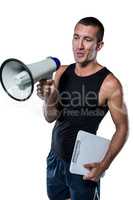 Trainer using megaphone while holding clipboard