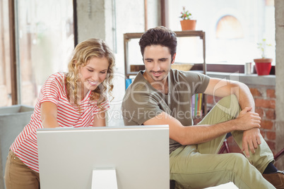 Business people using computer in office