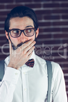 Nervous man covering mouth