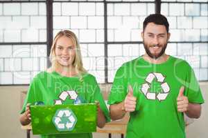 Portrait of cheerful volunteers in recycling symbol tshirts