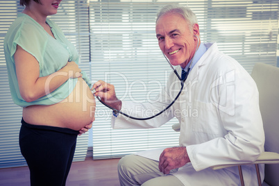 Portrait of doctor examining pregnant woman