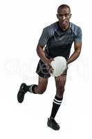 Portrait of determined sportsman running with rugby ball