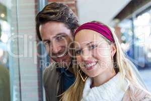 Smiling couple going window shopping