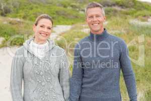 Smiling couple holding hands and hugging