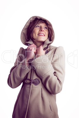 Attractive woman wearing a warm coat with hood raised