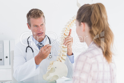 Doctor showing his patient a spine model