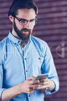 Serious man using smartphone