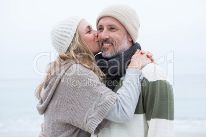 Cute woman giving a man a kiss