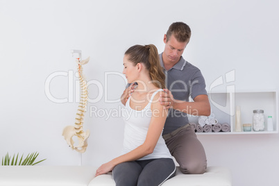 Doctor examining his patient neck