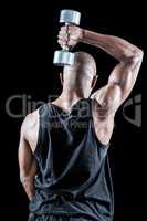 Rear view of muscular man exercising with dumbbell