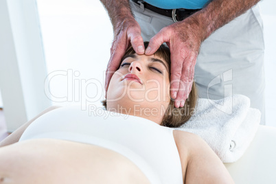 Calm woman receiving reiki treatment