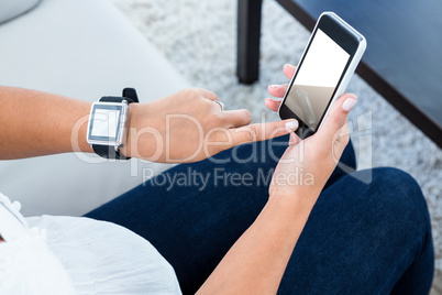 High angle view of woman scrolling on mobile phone