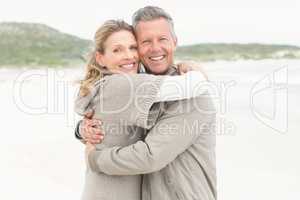 Smiling couple holding one another