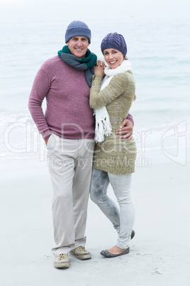 Smiling happy couple both wearing scarfs and hats