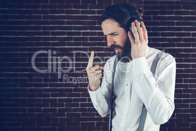 Serious hipster with eyes closed listening music