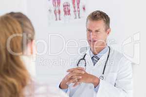 Doctor talking to patient wearing neck brace