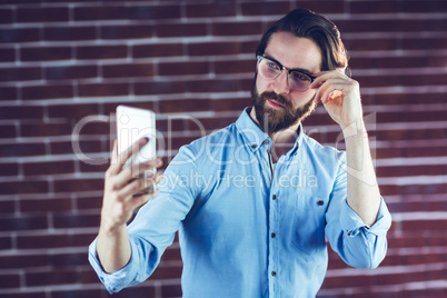 Handsome man taking picture of himself