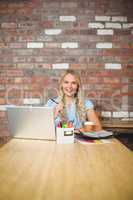 Portrait of woman working while sitting in office