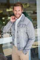 Young happy smiling man holding shopping bags