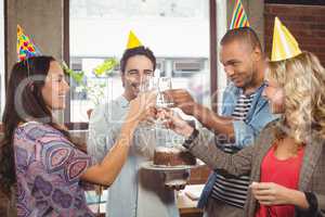 Colleagues toasting with champagne at birthday party