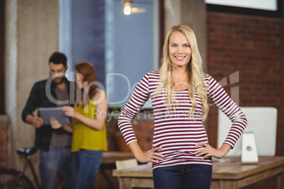 Portrait of happy woman with hands on hip