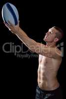 Confident handsome shirtless sports player holding ball