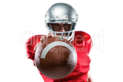 American football player in red jersey holding ball
