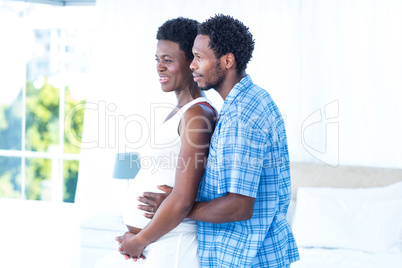 Husband embracing pregnant woman
