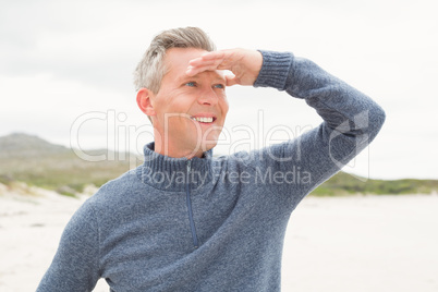 Smiling man looking out from the shore